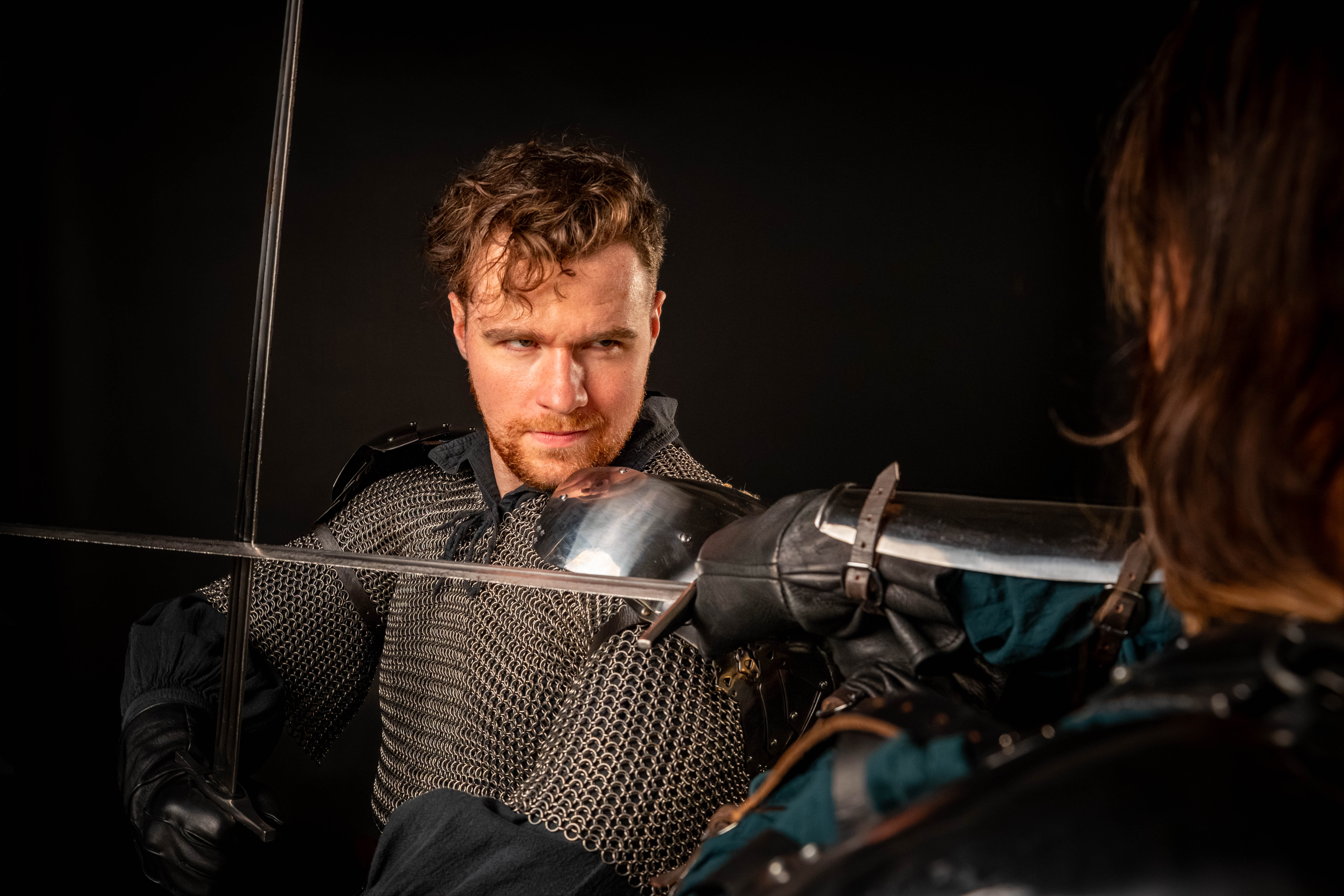 Knight Night Fights fighter locked in sword combat, studio lighting